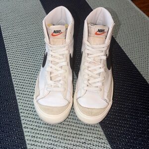 Nike White High-Top Sneakers with Black Swoosh and Orange Tongue Logo